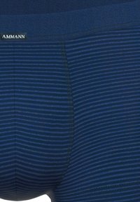 Blue striped men's boxer briefs with a soft elastic waistband. Material appears smooth with a breathable texture, featuring subtle tonal stripes.