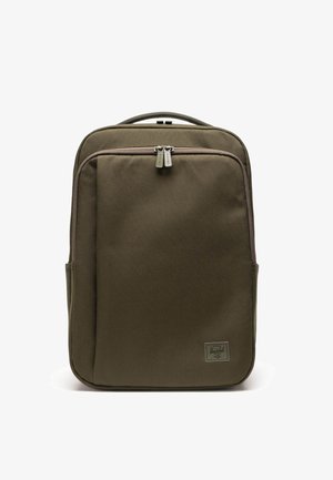 Olive green backpack with a rectangular shape, made of durable fabric, features two zippers, front pocket, and a logo patch.