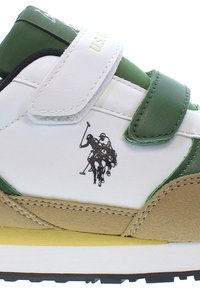 Sneaker featuring white and green leather, suede accents, Velcro strap, black polo player logo, and a yellow outsole.