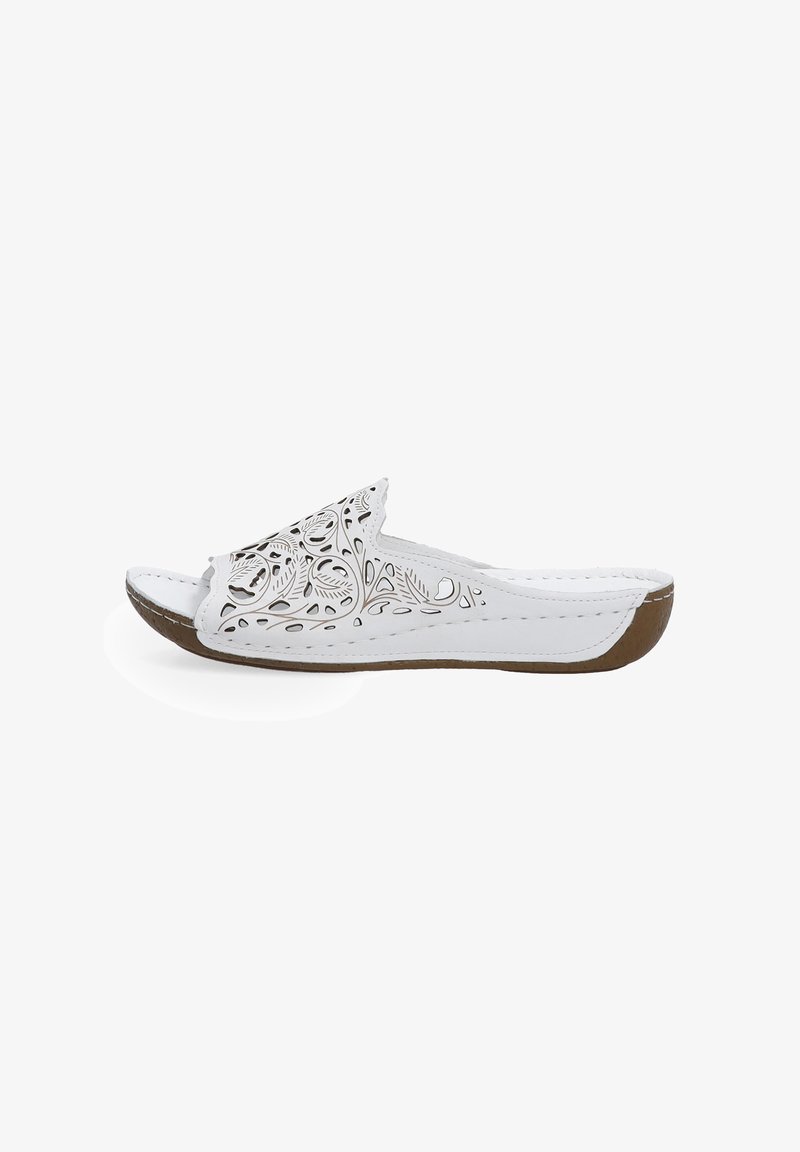 White slide sandal with cut-out floral design, smooth synthetic upper, brown rubber sole, rounded toe, and stitched detailing along the edges.