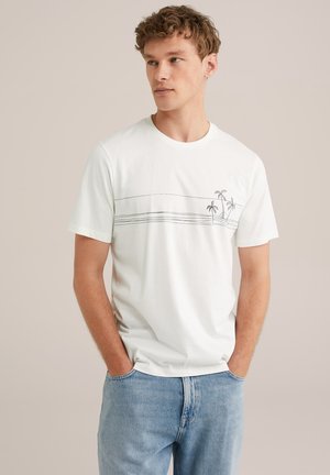 White cotton t-shirt featuring a minimalist print of palm trees and wavy lines across the chest. Crew neckline and short sleeves.