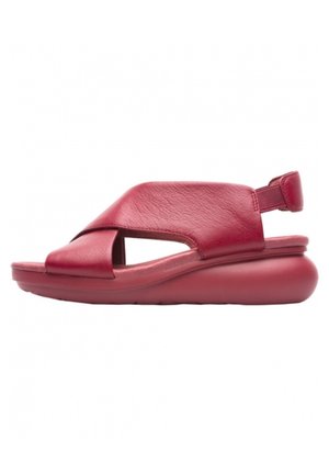 Sandalia de cuero rojo con diseño de tiras cruzadas, entresuela acolchada y correa ajustable en el talón para un ajuste seguro. Textura suave en toda la superficie.