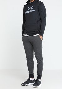 Under Armour Teplákové kalhoty - black