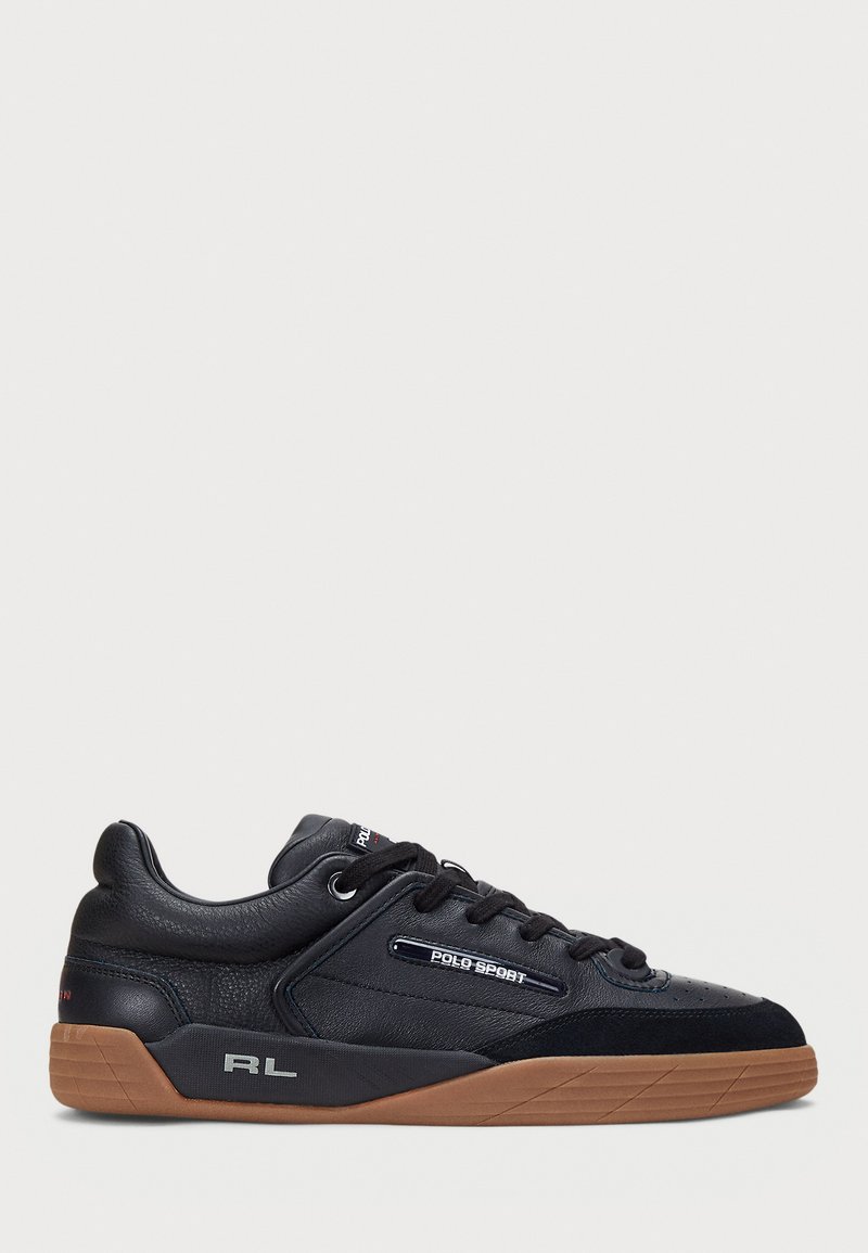 Black athletic sneakers made of leather and suede with a textured design, featuring a rubber gum sole and logo accents on the side.