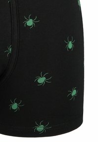 Czarne bokserki z bawełny z powtarzającym się zielonym wzorem pająka. Projekt zawiera dopasowany kształt i elastyczną talię.