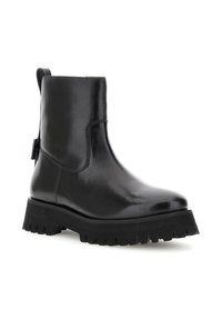 Botín de cuero negro hasta el tobillo con suela gruesa y antideslizante, tirador en el talón y cremallera lateral, diseñado para la moda resistente y la durabilidad.