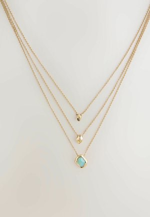 Gold multi-layer necklace featuring three delicate chains. The bottom chain has a turquoise stone pendant, and the upper chains have rounded accents.