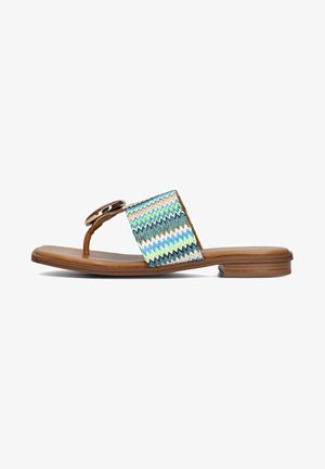 Flat sandals with a brown leather sole, featuring a multicolored zigzag woven strap and a decorative circular hardware accent.