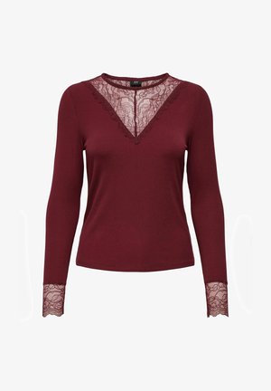 Bordeaux langemouwen top met ribbelstructuur en kantaccenten bij de halslijn en manchetten, met een V-vormig kantontwerp.