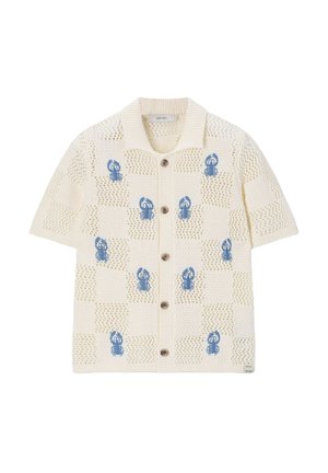 Cardigan en maille crème à manches courtes avec col, boutons en bois, motif en maille ajourée et motifs homards bleus uniformément espacés sur le devant.