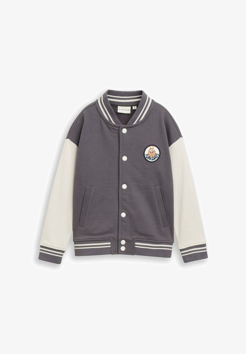 Veste universitaire grise et blanche avec col et poignets rayés, boutons-pression, poches avant et écusson rond avec personnage de dessin animé et texte "Funday".