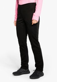 Schwarze Sportleggings aus dehnbarem Material, mit hohem Bund, seitlicher Reißverschlusstasche und kontrastierenden Einsätzen für zusätzlichen Stil.