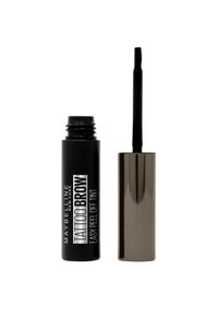 Teinture Peel Off Facile à Sourcils Maybelline Tattoo dans un container noir avec du texte blanc, accompagné d'un capuchon doré métallisé et d'un applicateur.
