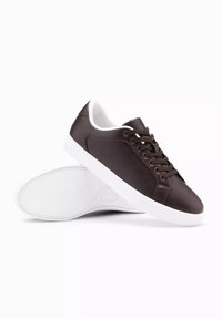 Sneaker in pelle marrone con suole in gomma bianca, punta rotonda, design con lacci e collare imbottito. Stile minimalista senza motivi o accenti.