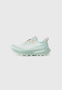 Light green running shoe featuring a mesh upper, textured midsole, and a rubber outsole with nubs for traction. Bright accents in orange.