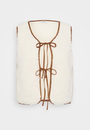 White faux fur vest with a brown suede trim, featuring a rounded neckline and a front tie closure with two loops.