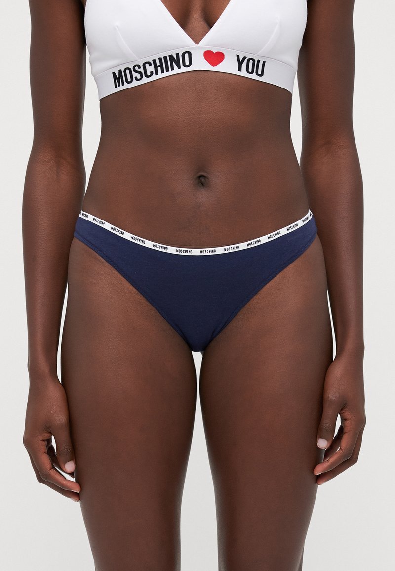 Navy cotton bikini briefs with a white branded elastic waistband featuring 'Moschino'. Smooth texture and minimal coverage design.