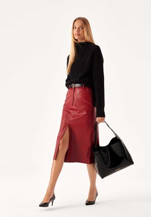 Black knit sweater, red leather pencil skirt with side slit, black patent leather handbag, and black high-heeled shoes.