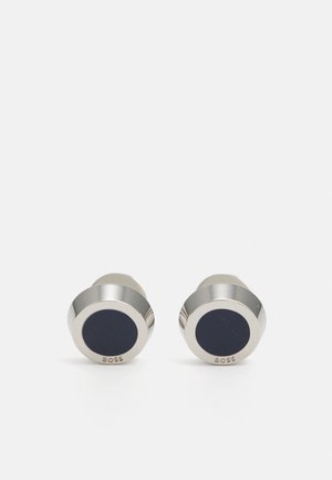 Silver-tone cufflinks with a round shape. Centered black enamel detail and a polished finish. Marked with brand name "BOSS" on one side.