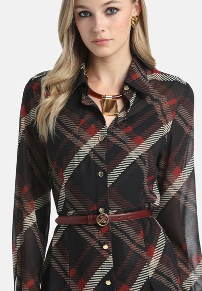 Melnas kvadrātveida krekls ar sarkaniem un bežiem rakstiem, garām piedurknēm, zelta pogām un saskaņotu bordo jostu ar apaļu sprādzi.