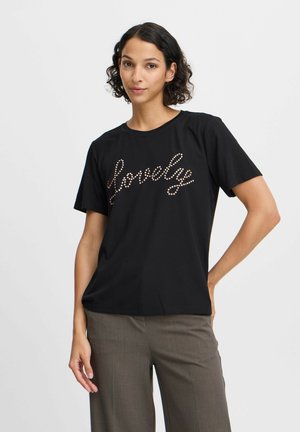 T-shirt noir à manches courtes, ornée du mot "lovely" en strass décoratifs. Encolure ronde simple et coupe décontractée. Assorti avec un pantalon marron.
