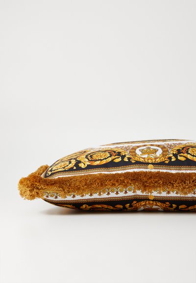 Decorative pillow with a black and gold pattern, featuring a plush, golden fringe along the edges. Rectangle shape with vibrant floral designs.
