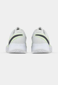 Valged sportkingad tekstureeritud võrguga pealismaterjaliga, millel on must ja laimiroheline aktsent. Ümar kuju ja kummist tallaga, mis tagab hea haarduvuse.