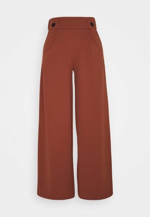Hoch taillierte, rostbraune Weithose mit Knopfdetails am Bund, gefertigt aus glattem, strukturiertem Stoff.