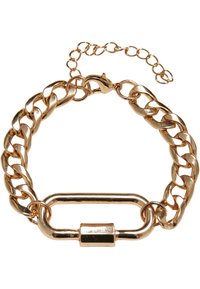 Bracelet en chaîne dorée avec de grands maillons entrelacés, doté d'une finition lisse et polie, ainsi que d'un détail de fermoir en barre allongée.
