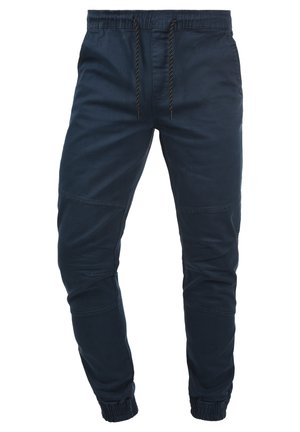Pantaloni jogger blu navy realizzati in un misto cotone, con vita elastica e cordino, polsini a coste e dettagli di cucitura discreti.