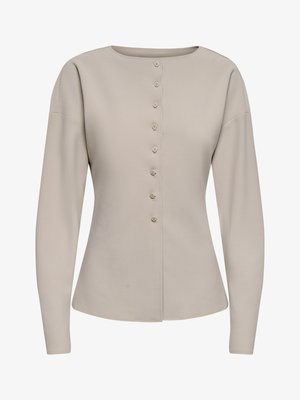 Světlé béžové propínací cardigan s dlouhými rukávy, kulatým výstřihem a přiléhavým pasem, zobrazený na bílém pozadí.