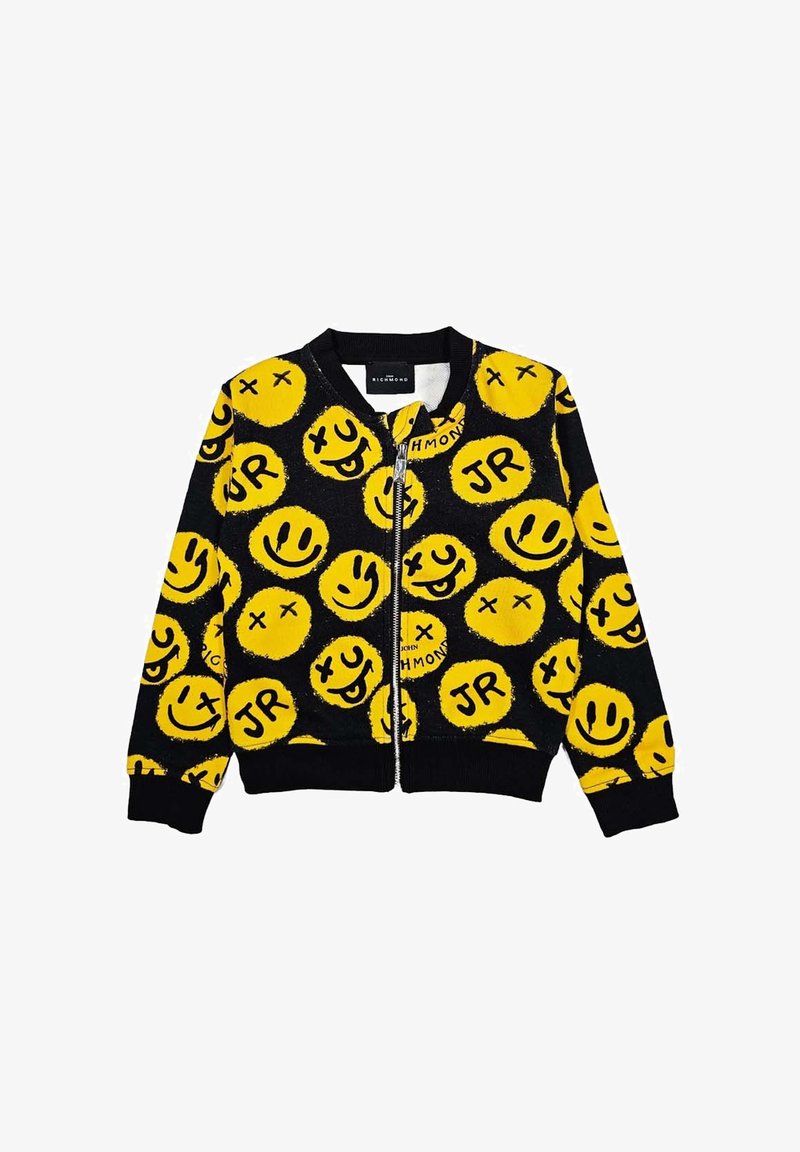 Giacca nera con zip decorata con un motivo di grandi facce sorridenti gialle e le lettere "JR." Polsini e collo a costine, texture morbida.