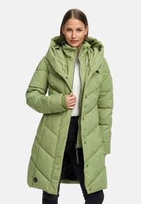 Light green padded coat with a large hood, featuring rectangular quilted sections, front zipper, and snap buttons. Black logo detail on hem.