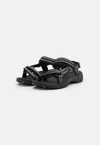 Black sandals featuring adjustable straps with a textured grey pattern, cushioned footbed, and traction outsole for stability.