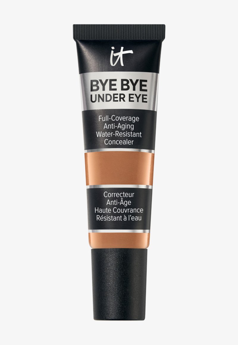 Tube de correcteur couvrant intégral Bye Bye Under Eye, anti-âge et résistant à l'eau, avec texte en anglais et en français sur un emballage noir et beige.