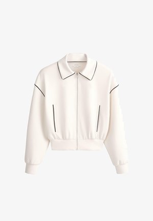 Biela bunda na zips s čiernym lemovaním na golieri, rukávoch a vreckách, s rebrovanými manžetami a pásom.