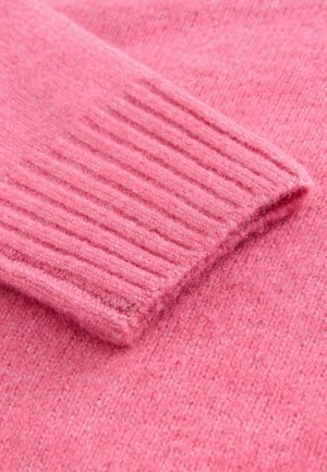 Pink knitted sweater fabric featuring a ribbed cuff. The texture is soft with a slightly fuzzy appearance and consistent, even coloring.