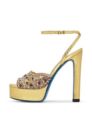 Sandalo con plateau e tacco alto color oro, cinturino alla caviglia, punta aperta e tomaia decorativa impreziosita da gemme marroni.