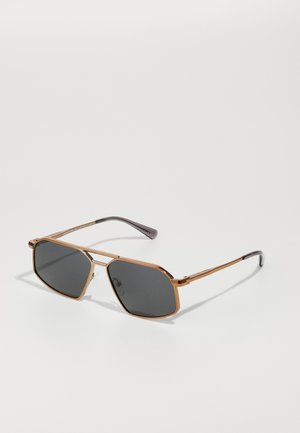 Bronze metal sunglasses with octagonal dark lenses, thin gold-colored frame, and black plastic arms featuring an engraved logo.