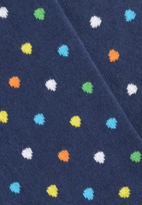 Temno modre nogavice imajo teksturiran vzorec z majhnimi barvnimi pikami v zelenem, rumenem, belem, modrem in oranžnem odtenku, enakomerno porazdeljenimi po tkanini.