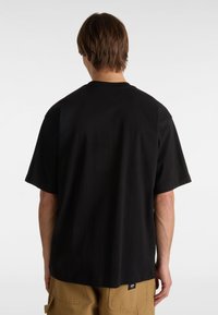 Black short-sleeve t-shirt made of cotton, featuring a relaxed fit and a round neckline, seen from the back with a small brand label.