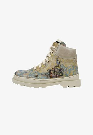 High-top canvas boots featuring a beige and multicolor patterned exterior, textured suede accents, and cream rubber sole with visible tread.