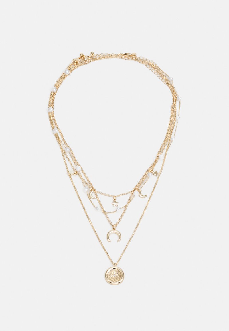 Gold multi-layer necklace featuring chains with moon and star charms, interspersed with small white beads, and a round pendant at the bottom.