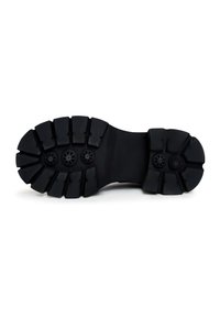 Semelle de botte en caoutchouc noir avec des crampons profonds et trois détails en motif circulaire, conçue pour une adhérence sur diverses surfaces.