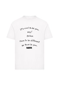 White cotton t-shirt featuring black text with phrases: "It's cool to be you," "Hey! Relax," and "Dare to be different. Be true to you."