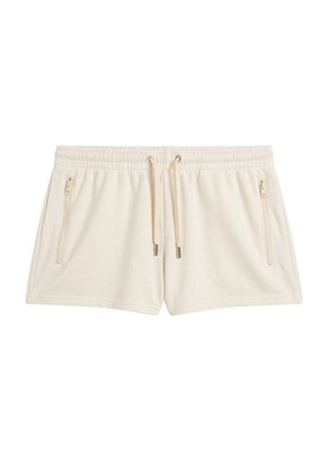 Beige short met trekkoord, elastische tailleband en twee verticale ritszakken aan de voorkant, gemaakt van zachte stof.
