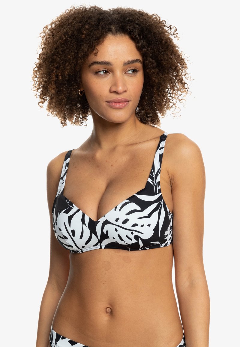 Black and white bikini top with a leaf pattern, featuring wide straps and a v-neck design, made from stretchy material.