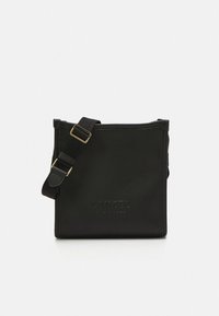 Black leather bag with a textured finish, featuring an adjustable strap and embossed logo detailing. Square shape with a minimalist design.