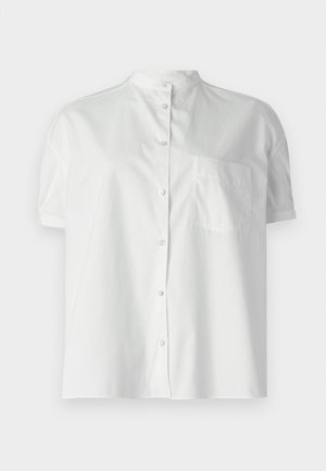 Camicia bianca a maniche corte con colletto alla cinese, bottoni frontali e una tasca sul petto. Realizzata in tessuto liscio con una leggera lucentezza.