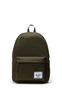 Green, fabric backpack with a rounded shape, front zipper pocket, and a top handle. Features a white brand patch on the front.
